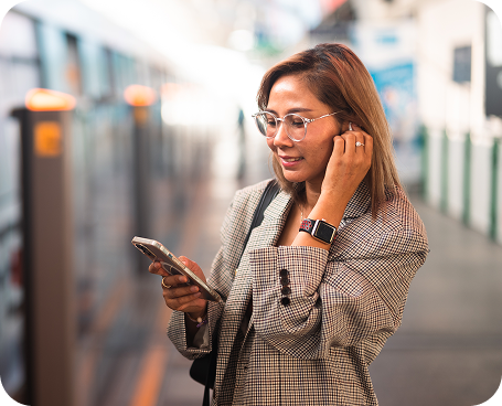 Woman using phone by train