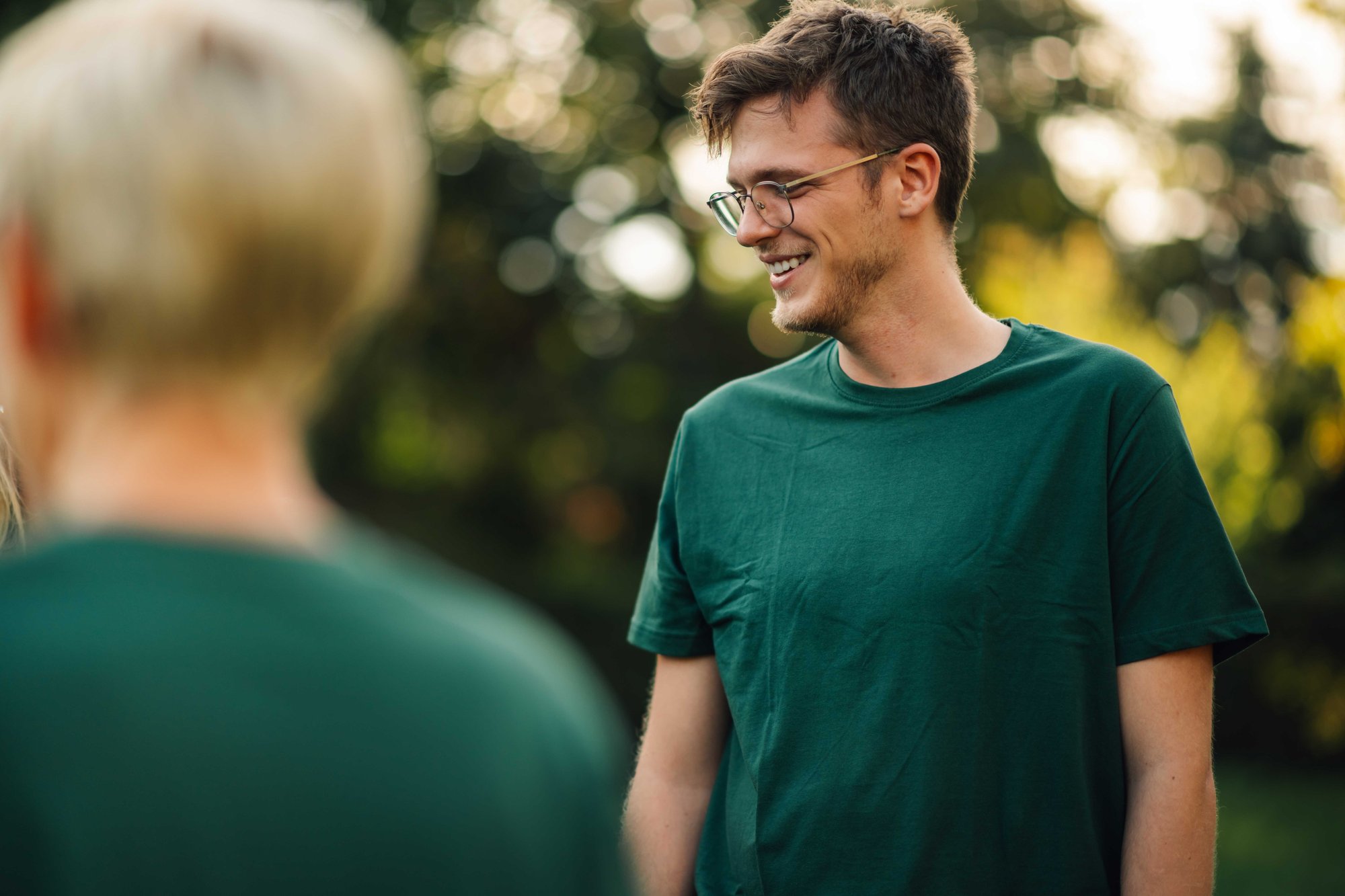 Volunteering man in a green t-shirt smiling