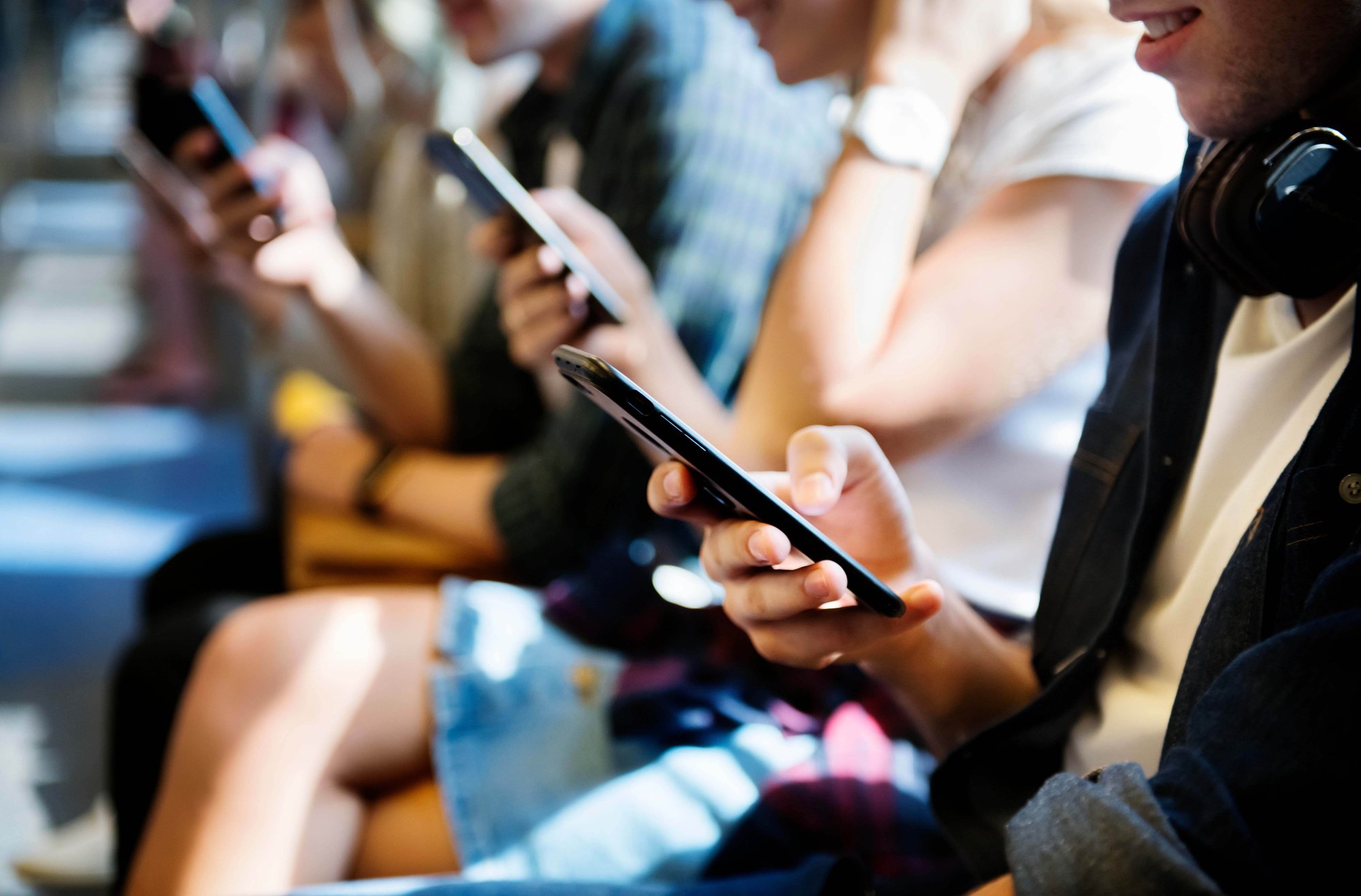 Various devices being viewed by people sitting outside