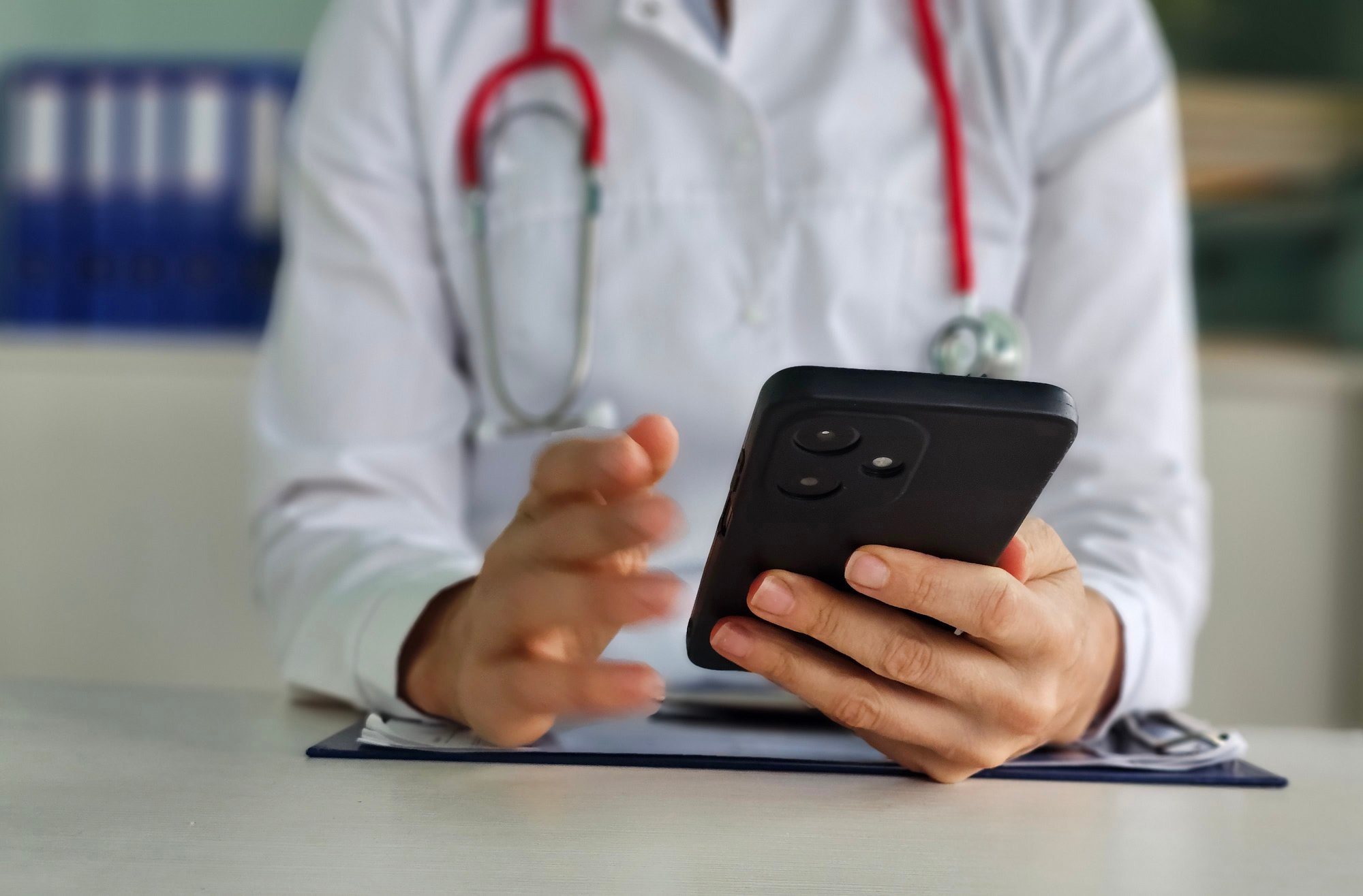 Close up doctor's hands holding a mobile phone