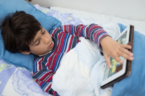 Child patient in hospital bed using tablet-1