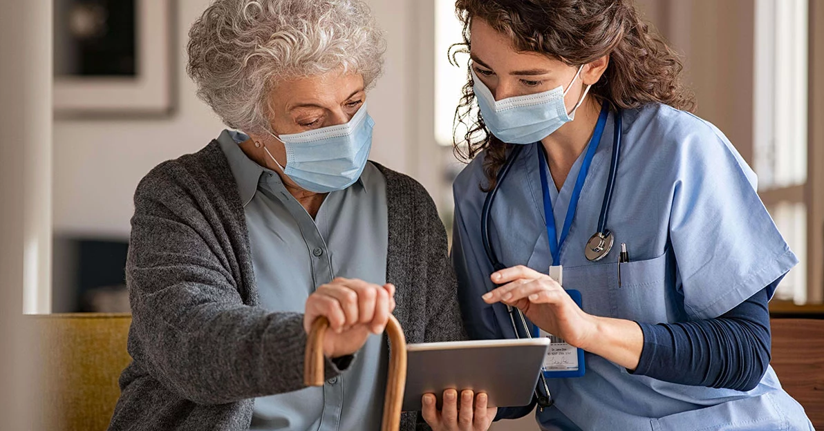 Nurse and patient looking at tablet